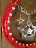 STARRY NIGHT Luck Adorned Lucky Horseshoe is a glossy red shoe with a silver star centerpiece, a crystal star and a little angel to watch over you. This shoe has a silver chain to hang by and white diamond-like Swarovski crystals.
